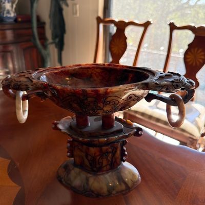 Intricately carved Chinese style soapstone or jade censer vessel with loose ring handles on a matching fitted stand.