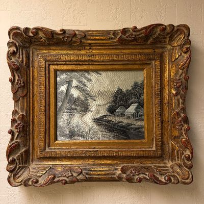 Framed embroidered silk textile artwork depicting a monochrome landscape scene, housed in an ornate carved giltwood frame.