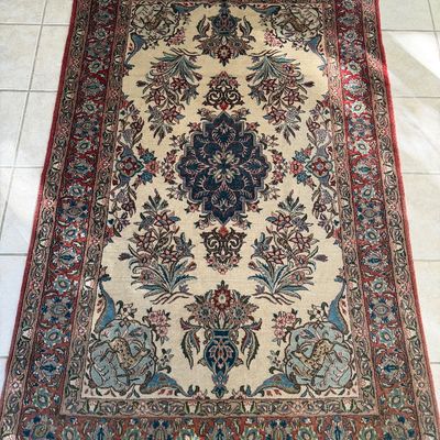Hand-knotted Persian-style area rug featuring a central medallion with floral motifs, animal depictions, and a multi-tiered border in...