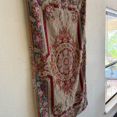 French Aubusson-style woven tapestry wall hanging featuring floral borders and a central rosette medallion.