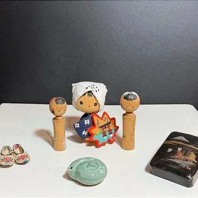 A Korean Celadon Water Dropper & Japanese Souvenirs; Kokeshi Dolls, Lotus Slippers And Lacquered Box