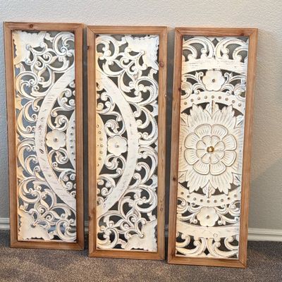 Three-piece rustic carved wall art triptych featuring distressed white medallion details set in natural wood frames.