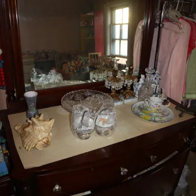 Sale Photo Thumbnail #47: Dark wood dresser with large matching mirror, glass knobs, and a display of assorted vintage glassware, ceramics, and decor items.