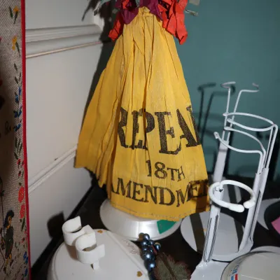 Sale Photo Thumbnail #80: Vintage Prohibition era crepe paper party favor umbrella reading "Repeal 18th Amendment", displayed alongside various white plastic doll stands.