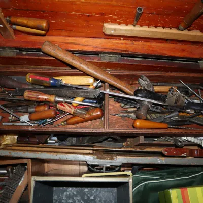 Sale Photo Thumbnail #160: Vintage wooden carpenter's chest filled with an assortment of hand tools, including hammers, screwdrivers, chisels, and files.