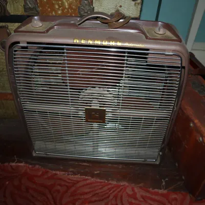 Sale Photo Thumbnail #65: Vintage Kenmore Automatic portable box fan in brown housing with a chrome grill, featuring top control knobs and a carrying handle.