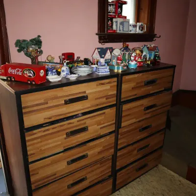 Sale Photo Thumbnail #166: Pair of vintage butcher-block style tall dressers topped with collectibles including a Coca-Cola toy truck and Christmas figurines.