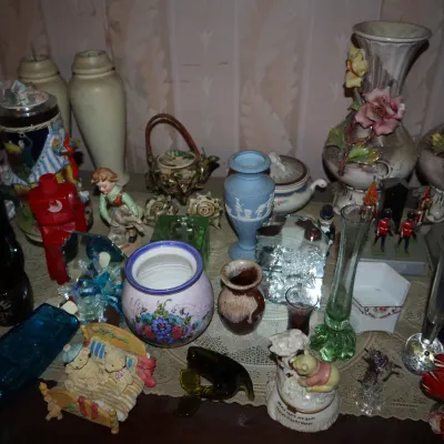 Sale Photo Thumbnail #108: Collection of decorative vintage collectibles and ceramics, including fine china vases with applied floral details, a blue Jasperware vase, figurines, and colorful glassware.