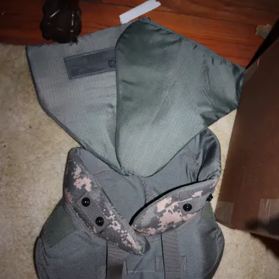 Sale Photo Thumbnail #105: U.S. military Universal Camouflage Pattern (UCP) body armor attachments, including a yoke and collar assembly with soft armor inserts.