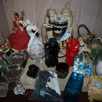 Sale Photo Thumbnail #107: Collection of vintage decorative collectibles, including a Spanish flamenco dancer doll, a German beer stein, cut glass ashtrays, blue jasperware, and small ceramic figurines.