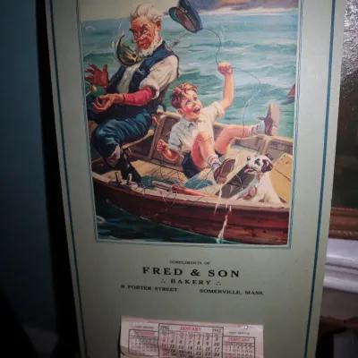Sale Photo Thumbnail #76: Vintage 1942 advertising calendar from Fred & Son Bakery of Somerville, Mass., featuring an illustration of a grandfather, boy, and dog in a boat.