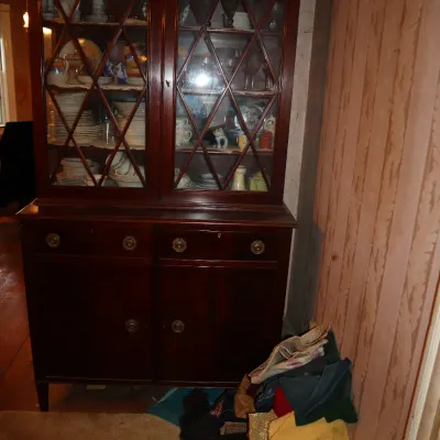 Sale Photo Thumbnail #126: Traditional dark mahogany china cabinet with glass lattice doors, drawers, lower storage cabinet, and contents.