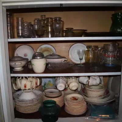 Sale Photo Thumbnail #111: A hutch displaying vintage glassware, teacups, serving bowls, and matching china sets on multiple shelves.