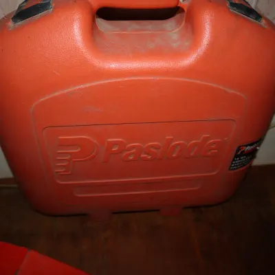 Sale Photo Thumbnail #92: Red molded plastic Paslode power tool carrying case with integrated handle.