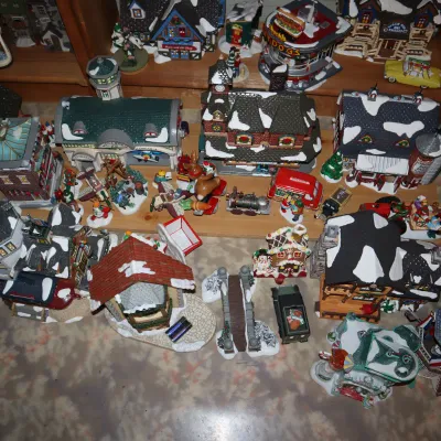Sale Photo Thumbnail #10: Large collection of illuminated Christmas village buildings, figurines, and accessories, including Department 56 and Lemax pieces.