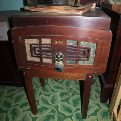 Sale Photo Thumbnail #59: Vintage Zenith wooden floor-model radio and record player cabinet, topped with a stack of 78 RPM record albums.
