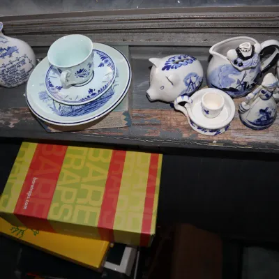 Sale Photo Thumbnail #174: Collection of blue and white Delfts Delftware ceramics, including small pitchers, saucers, a piggy bank, and figurine knick-knacks.