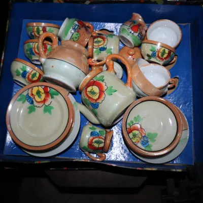 Sale Photo Thumbnail #75: Vintage miniature porcelain tea set with hand-painted floral details, resting in its original blue insert box.