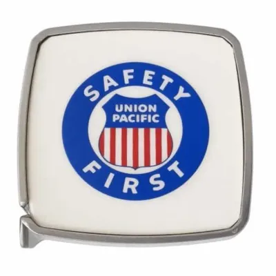 Sale Photo Thumbnail #29: Lot 102: Vintage Union Pacific Safety First Tape Measure Front features a blue circle with “Safety First,” Union Pacific shield logo with red-and-white stripes. Reverse marked “Presented in Appreciation,” “Safety and Courtesy Department,” “1