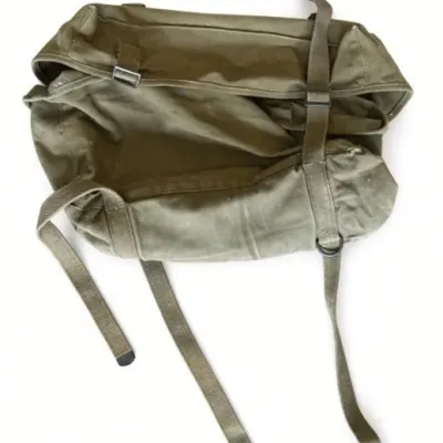 Sale Photo Thumbnail #56: Lot 129: Vintage olive-green canvas US military gear bag. Heavy canvas construction with multiple webbing straps, metal buckles, and D-rings.