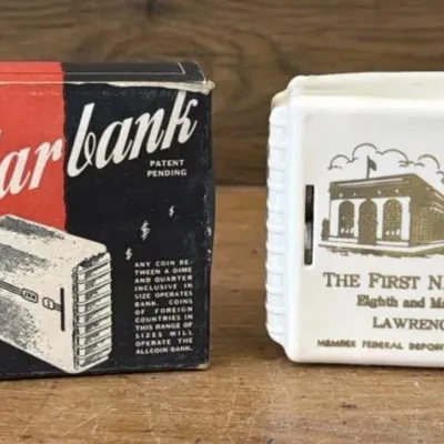 Sale Photo Thumbnail #426: Lot 526: Vntg First National Bank Lawrence Kansas - calendar coin Bank
