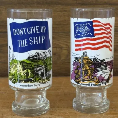 Sale Photo Thumbnail #448: Lot 548: 1970s Anchor Hocking / National Flag Foundation / Coca-Cola Heritage Collector glasses