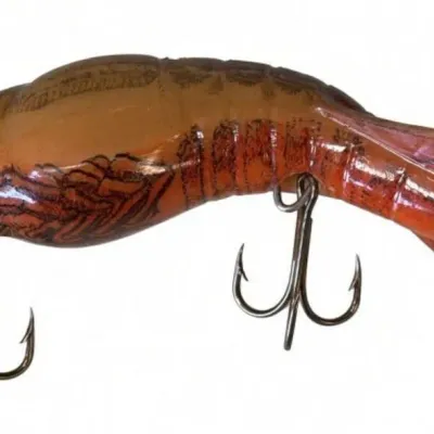 Sale Photo Thumbnail #117: Lot 190: Vintage hard-plastic fishing lure shaped like a shrimp or crawfish. Orange-to-brown gradient body with detailed shell/scale patterns, two treble hooks. Shows some paint wear. Classic mid-century style
