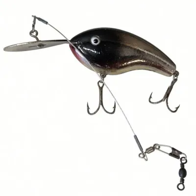 Sale Photo Thumbnail #123: Lot 196: Vintage hard-plastic fishing lure. Metallic silver-to-black body with diving lip, two treble hooks, and attached leader line with swivels. Shows light wear. Classic mid-century crankbait style