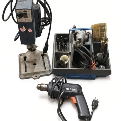 Sale Photo Thumbnail #47: Lot 120: Black & Decker D1000 corded electric drill, plus a matching drill press stand and accessory caddy filled with bits, hole saws, and brushes. Includes a package of Sears power wood boring bits.