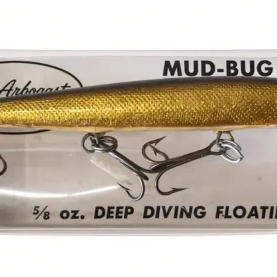 Sale Photo Thumbnail #127: Lot 199a: Fred Arbogast Mud-Bug deep diving floating lure in original yellow packaging. Gold-scale hard-plastic bait, 5/8 oz, with clear diving lip and treble hooks