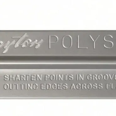 Sale Photo Thumbnail #28: Lot 101: Vintage metal sharpening tool. Long rectangular bar marked “Nylon POLYSHARP” with instructions to sharpen points in the groove and cutting edges across the flats.
