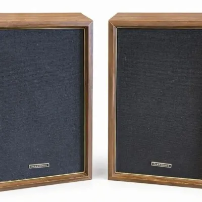 Sale Photo Thumbnail #61: Lot 134: Pair of vintage Panasonic SB-207 2-way speaker systems. Wood-grain cabinets with black cloth grilles and gold trim. Model SB-207, 8O impedance, 36W peak input, made in Japan by Matsushita. Classic mid-century bookshelf speaker