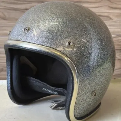 Sale Photo Thumbnail #366: Lot 467: Vintage Arthur Fulmer open-face motorcycle helmet, silver / champagne heavy metalflake. Size medium. American-made, late 1960s–1970s, the era when Fulmer was a staple on the road and at the drags.
