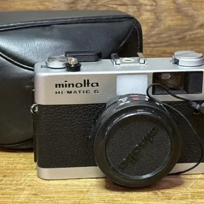 Sale Photo Thumbnail #569: Lot 673: vintage Minolta Hi-Matic G 35mm compact rangefinder camera with a black leather case