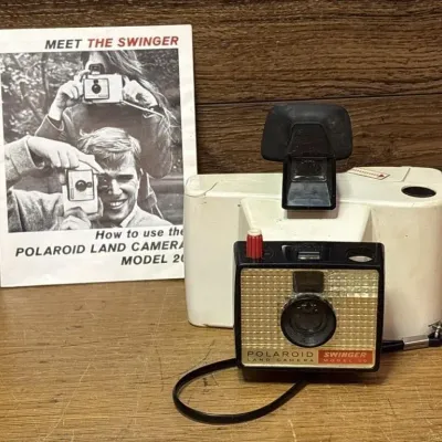Sale Photo Thumbnail #565: Lot 669: Vintage swinger Polaroid Land Camera