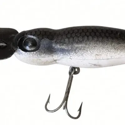 Sale Photo Thumbnail #121: Lot 194: Vintage hard-plastic fishing lure. White-to-black Vintage hard-plastic fishing lure. White-to-black gradient body with scale pattern, metal diving lip/blade, and two treble hooks