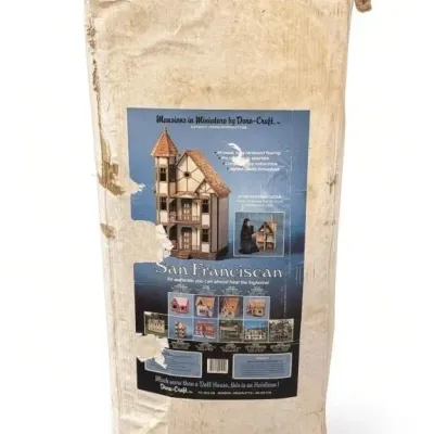 Sale Photo Thumbnail #40: Lot 113: Dura-Craft “San Franciscan” dollhouse kit (SF 550) in original cardboard packaging. All-wood construction with 7 rooms and 2 stairways, size approximately 18 x 22 x 43 inches. Includes authentic period reproduction details - boxes and rough c