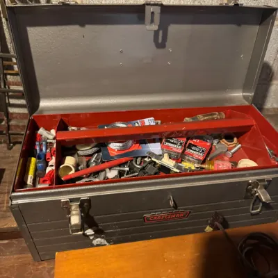 Sale Photo Thumbnail #74: Vintage Craftsman gray metal toolbox with a removable red inner tray, filled with various hand tools, hardware, and small accessories.