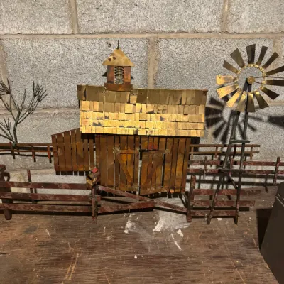 Sale Photo Thumbnail #73: Vintage metal farm scene wall sculpture featuring a barn, fence, and windmill in copper and brass tones.