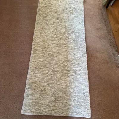 Sale Photo Thumbnail #154: Rectangular beige carpet runner with light staining, laid out on carpeted flooring.