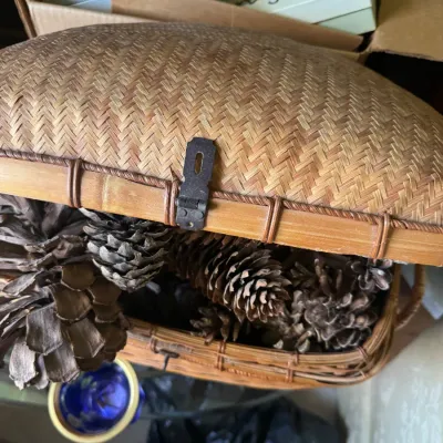 Sale Photo Thumbnail #53: Vintage woven bamboo or wicker sewing basket with a hinged lid, filled with decorative pinecones.