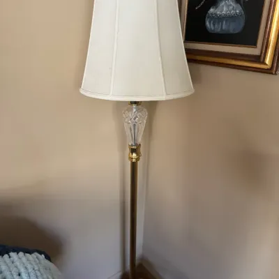 Sale Photo Thumbnail #287: Traditional brass floor lamp featuring a cut crystal urn accent and a off-white fabric lampshade.