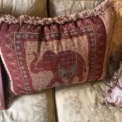 Sale Photo Thumbnail #55: Rectangular tapestry throw pillow featuring an elephant motif in warm red and beige tones, finished with fringe trim.