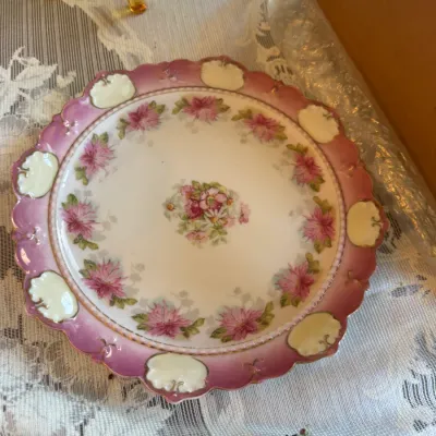 Sale Photo Thumbnail #415: Antique porcelain cake plate featuring a hand-painted floral design, pink gradient border with scalloped edges, and molded relief accents.