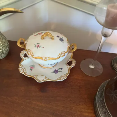 Sale Photo Thumbnail #61: Vintage porcelain covered tureen on a matching underplate, decorated with delicate floral motifs and gilt trim.