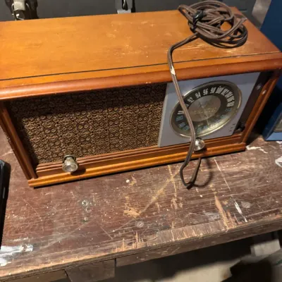 Sale Photo Thumbnail #10: Vintage Zenith AM/FM tabletop radio featuring a wooden cabinet and woven speaker grille, circa 1950s-1960s.