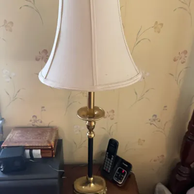 Sale Photo Thumbnail #185: Vintage brass and black metal table lamp with a cream fabric bell shade.