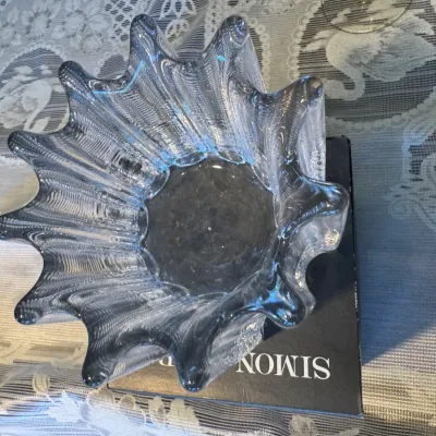 Sale Photo Thumbnail #62: Simon Pearce clear art glass bowl with a fluted, wavy rim, resting on its original black presentation box.