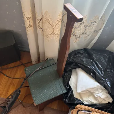 Sale Photo Thumbnail #165: Vintage wooden shoe shine valet box with a T-bar footrest and green textured top, featuring visible paint splatter and wear.