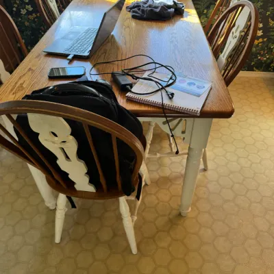 Sale Photo Thumbnail #189: Rectangular wooden dining table with painted white legs and a matching set of country-style spindle-back chairs.